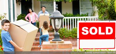 A family moving into their first home with boxes