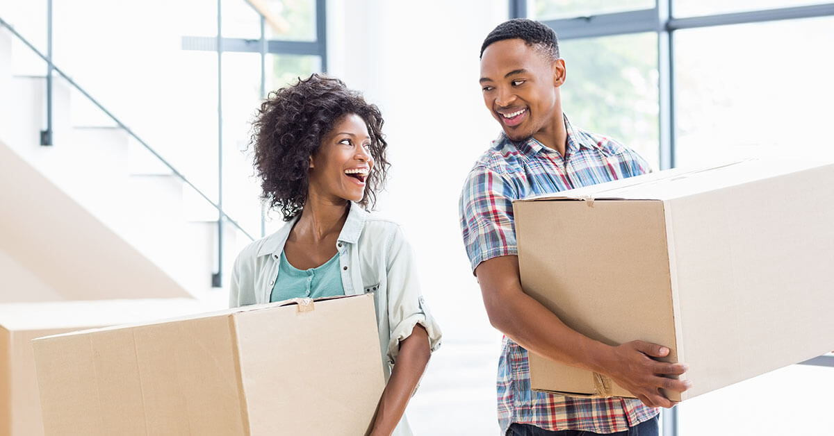 new homeowners moving boxes in