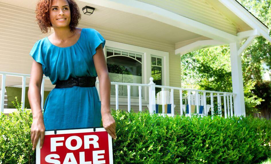 realtor with a for sale sign