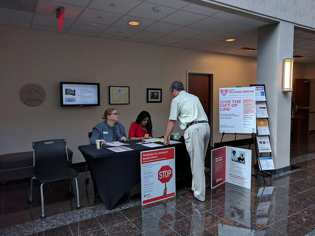 A man asking two ladies some questions