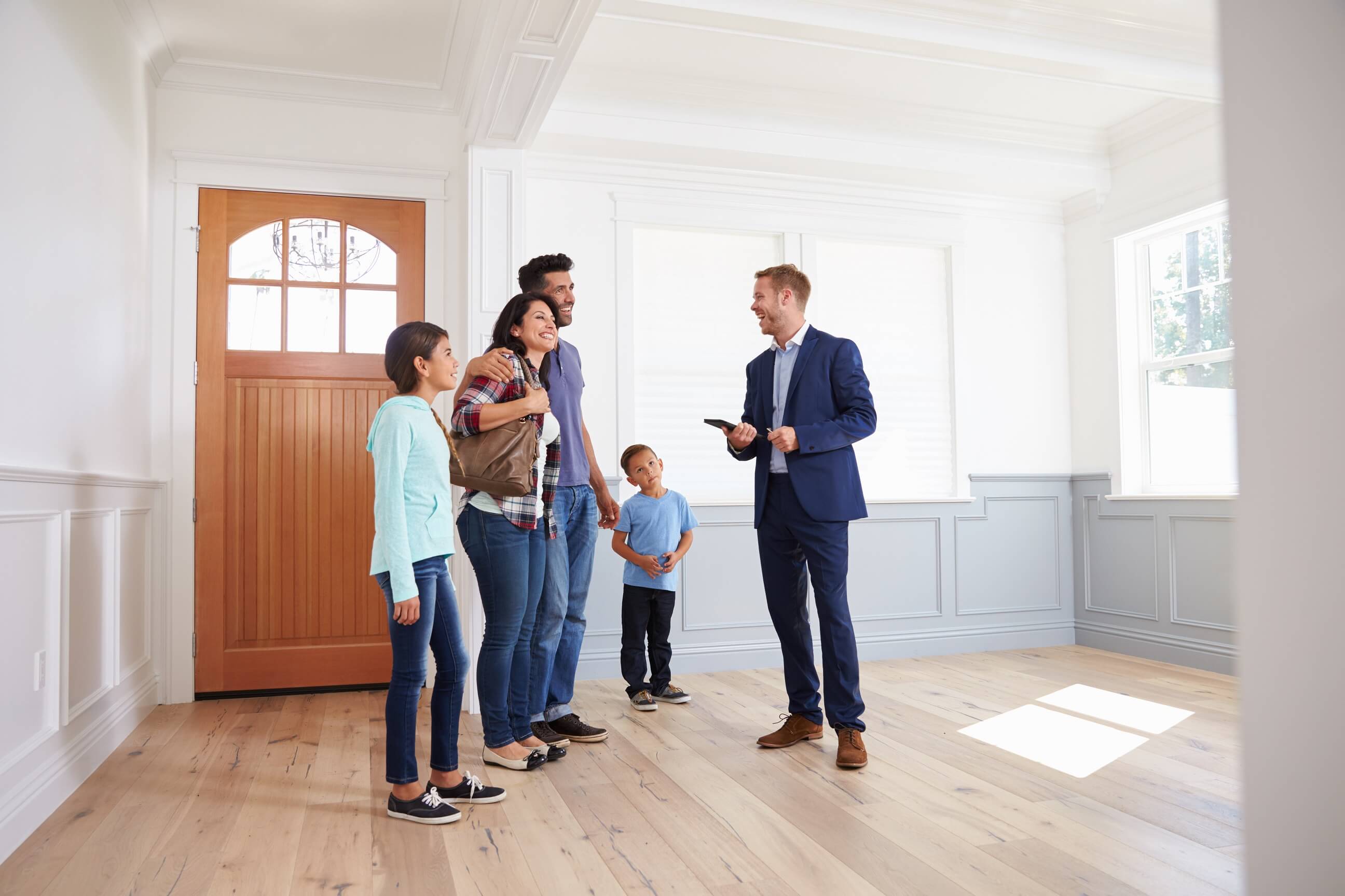 Realtor showing a family a house