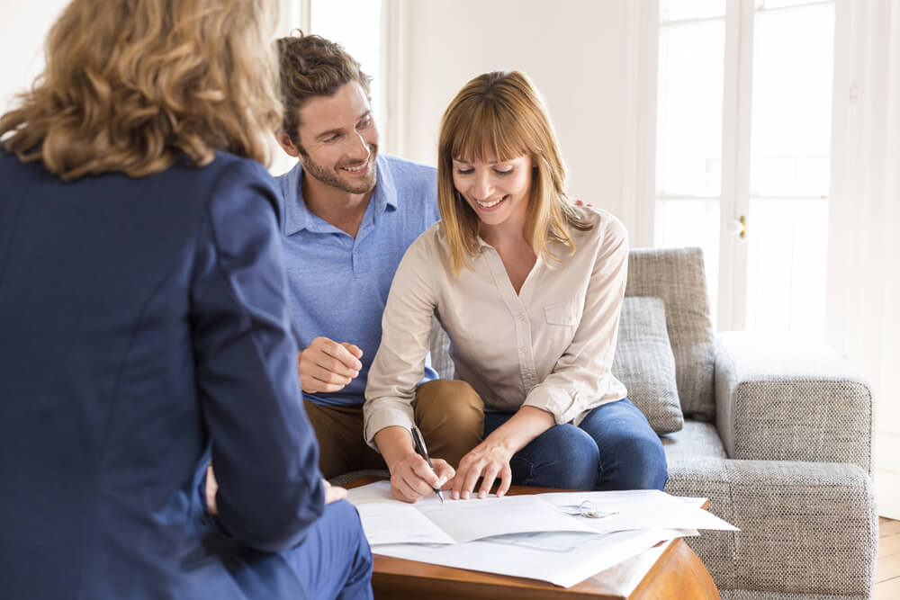 A couple signing a home contract