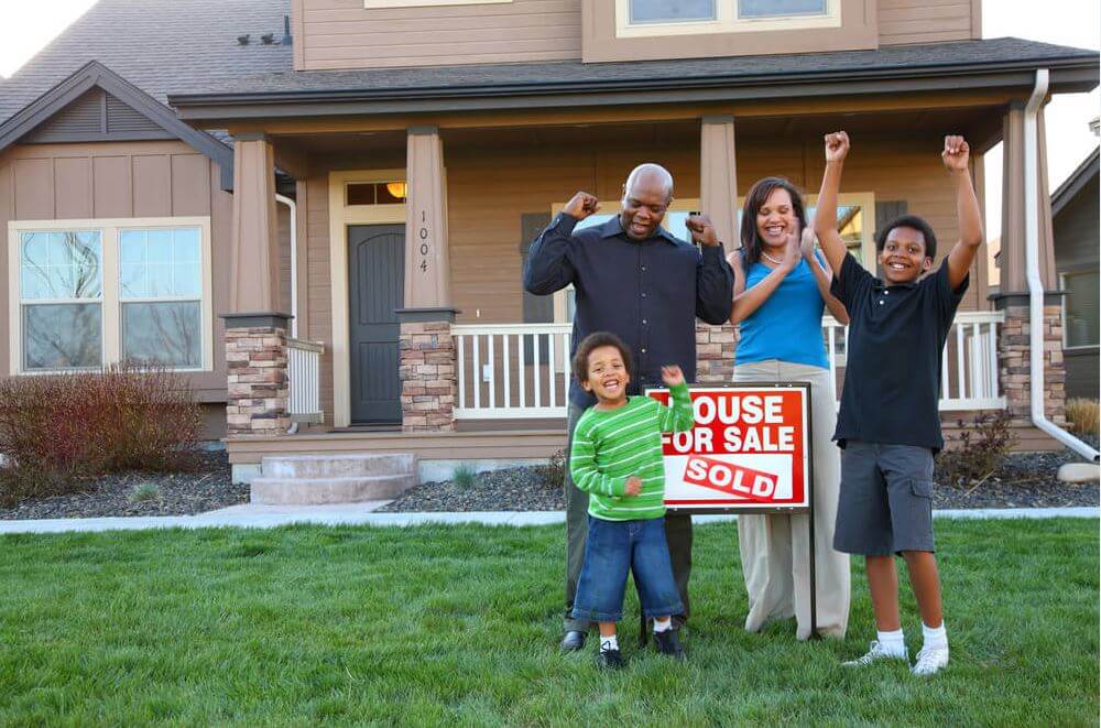 A family of 4 celebrates buying a house