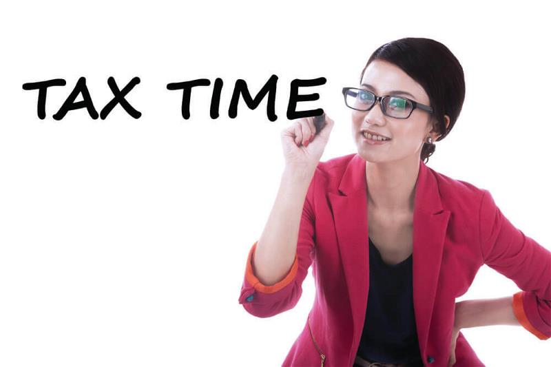 A lady with a marker and Tax time written in bold black
