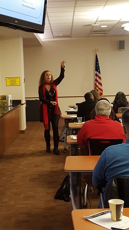 Linda taking questions from a participant in a class