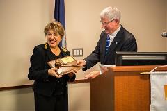 Virgil Frizzell and Mary Bayat exchanging gavel