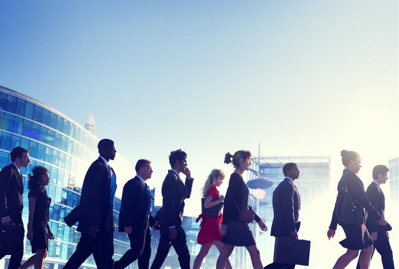 A gropu of corporately dressed people walking in a direction