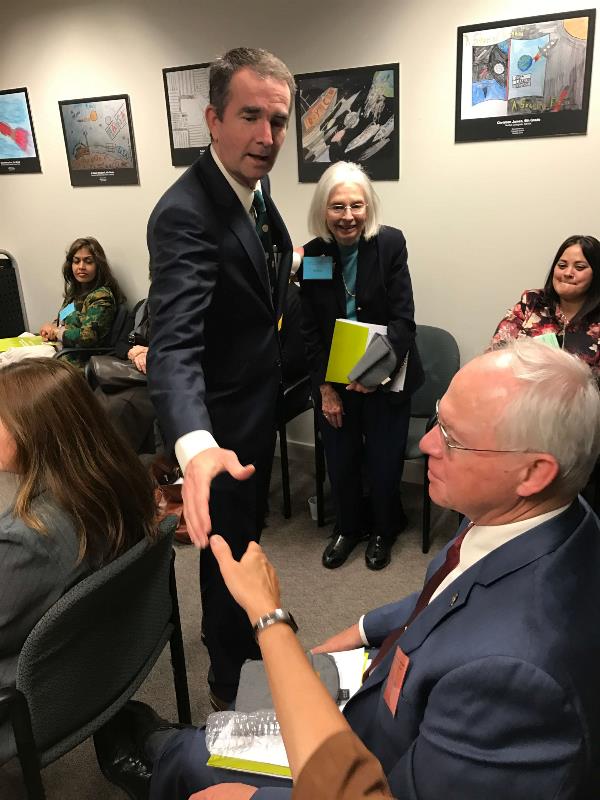 Virginia Governor shakes hand with a member