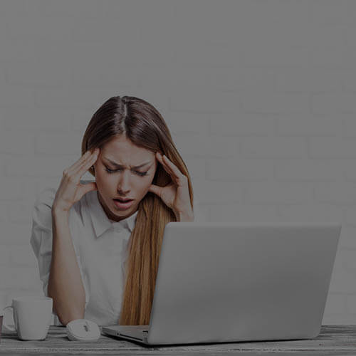 A frustrated lady infront of her laptop