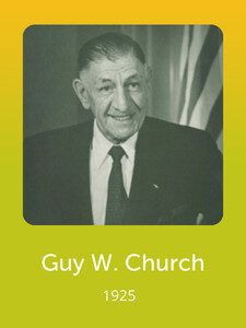 A person in formal attire stands smiling with a flag in the background. The text "Guy W. Church, 1925" is written below.