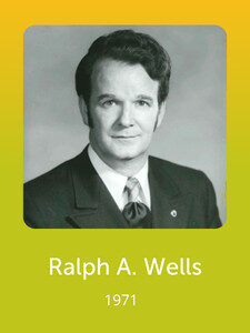 A black-and-white portrait of a person in a suit from 1971, named Ralph A. Wells, displayed against a yellow background.