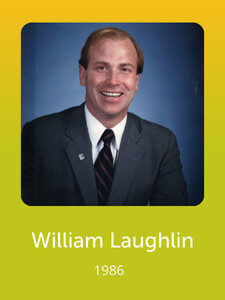 A smiling person in a suit and tie is shown against a blue background. The text below reads "William Laughlin, 1986."