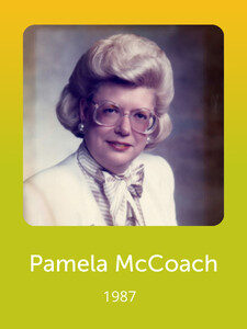 A person with styled hair and glasses wearing a white blazer and scarf, against a neutral background. Text below reads "Pamela McCoach 1987."