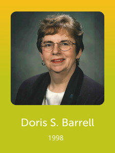 A person wearing glasses and a dark jacket is pictured against a gradient background. The text below reads "Doris S. Barrell, 1998."