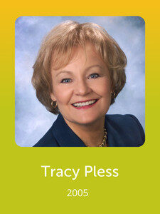 A person with short hair smiles at the camera against a blue background. The image has a yellow border, labeled "Tracy Pless, 2005."