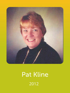 A person smiling in a portrait with short hair wearing a dark top. The text below reads "Pat Kline, 2012" on a yellow background.