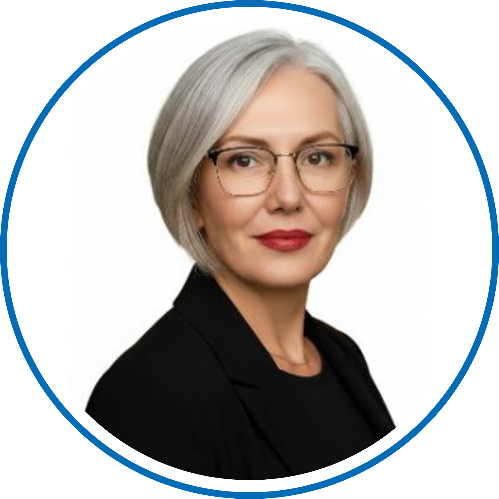 A person with gray hair and glasses is pictured against a white background, wearing a black outfit and a confident expression.