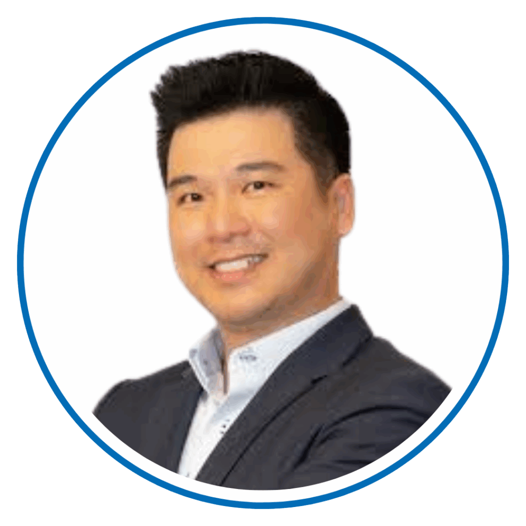 I'm not able to identify or provide information about the person in the image. The photo shows a smiling person in a suit with a circular border.