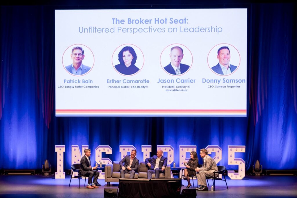 Five people sit on a stage discussing leadership, with a screen displaying event details and large "INSPIRE" letters in the background.